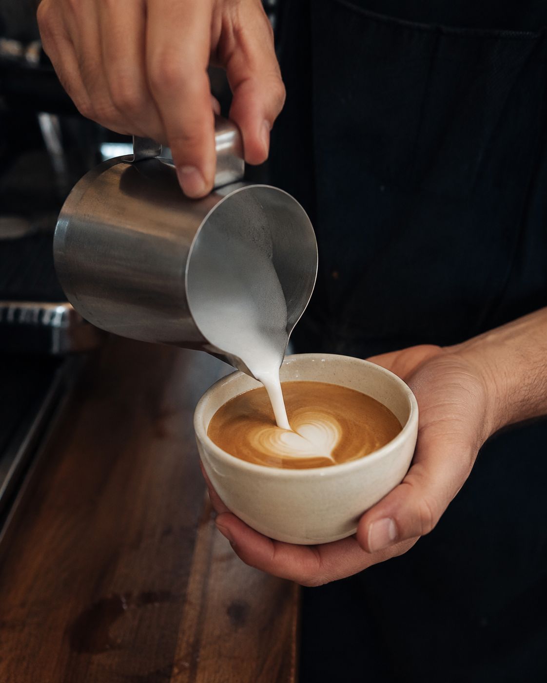 Northpoint barista pouring latte art into a freshly prepared coffee